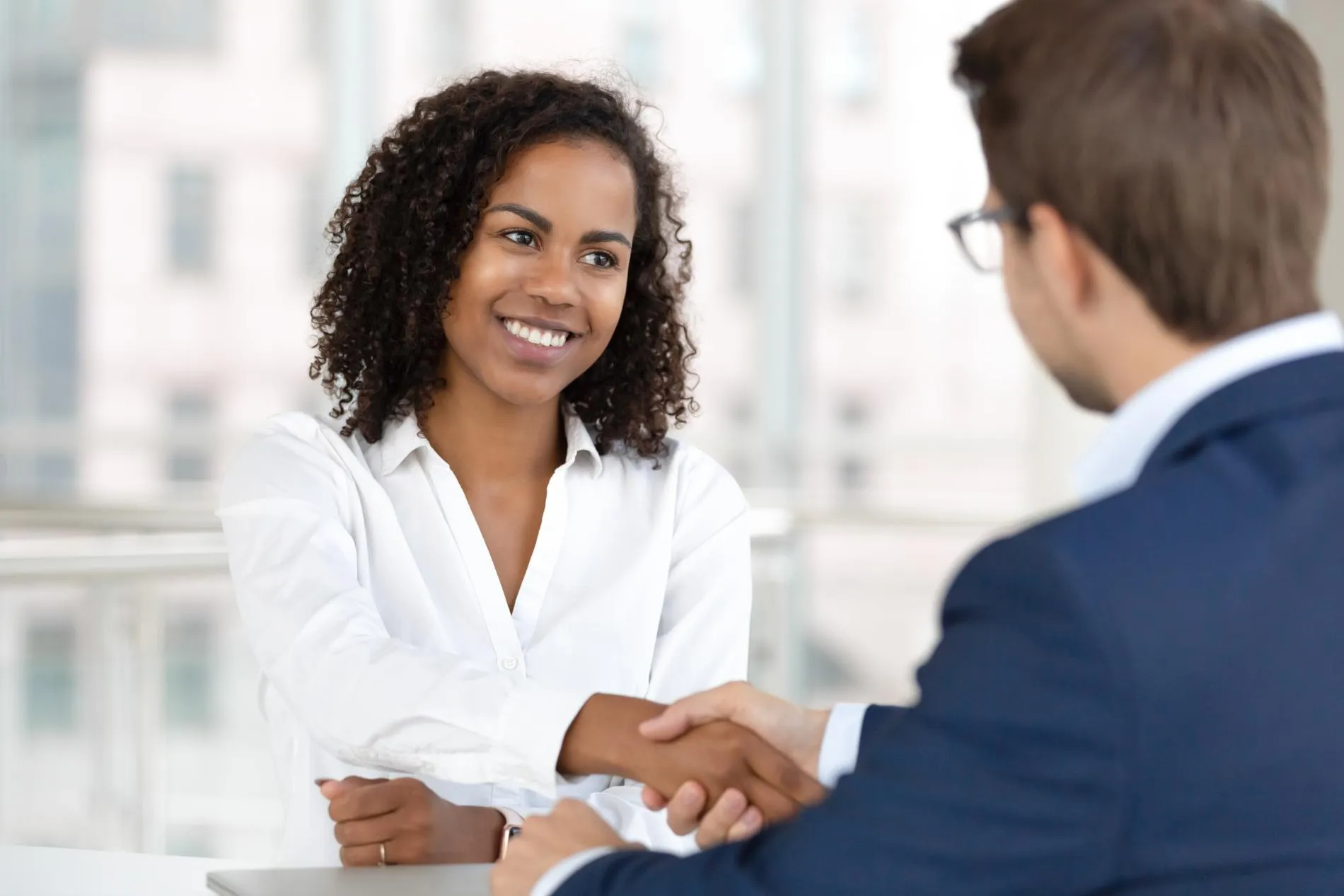 A woman shaking hands with her lawyer