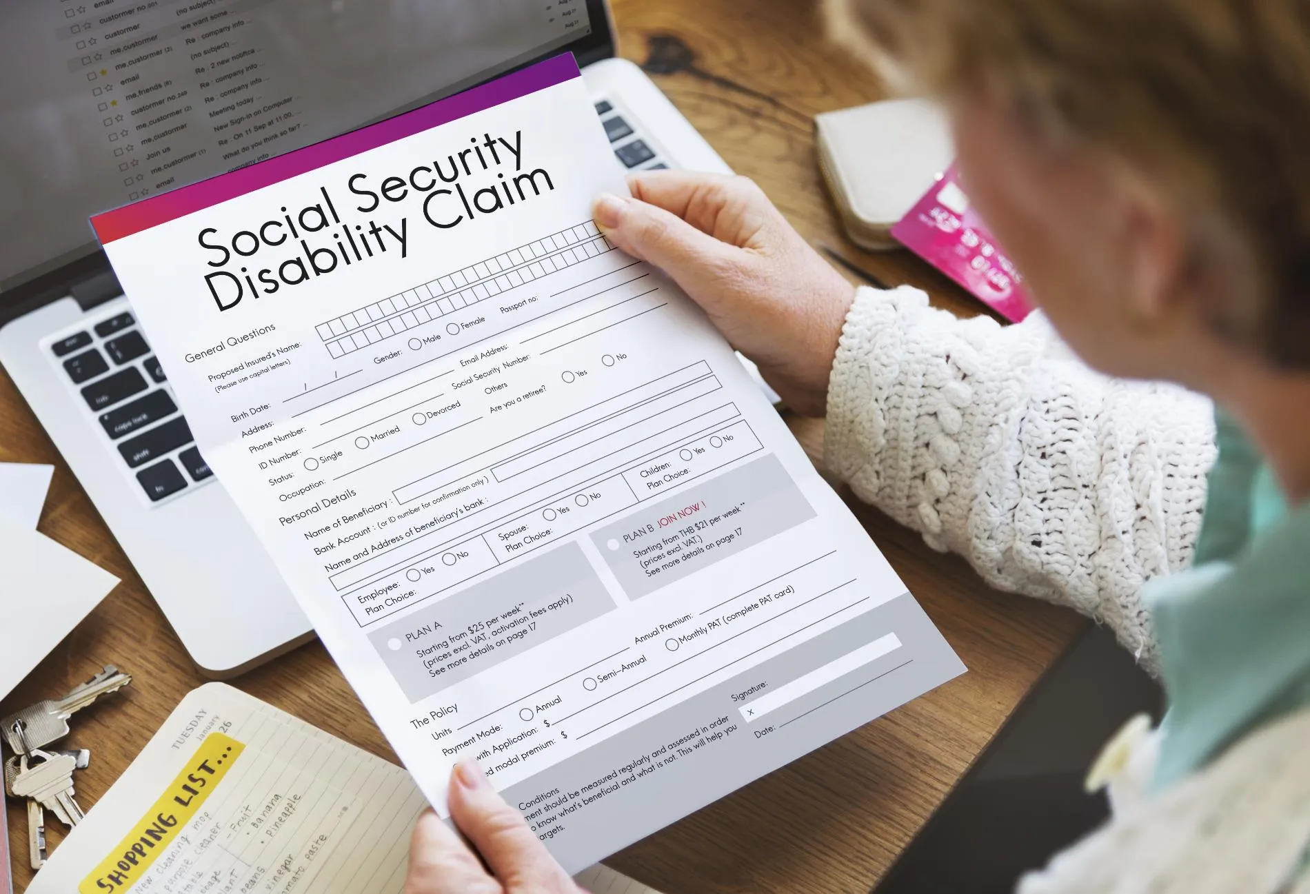 A woman holding a social security disability claim form