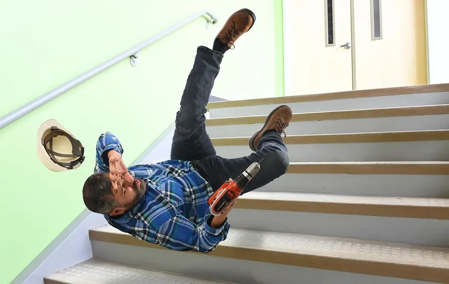 A worker slipping and falling off a staircase