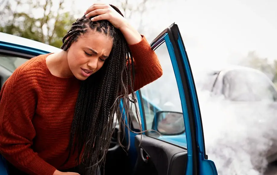 A woman holding her head in pain