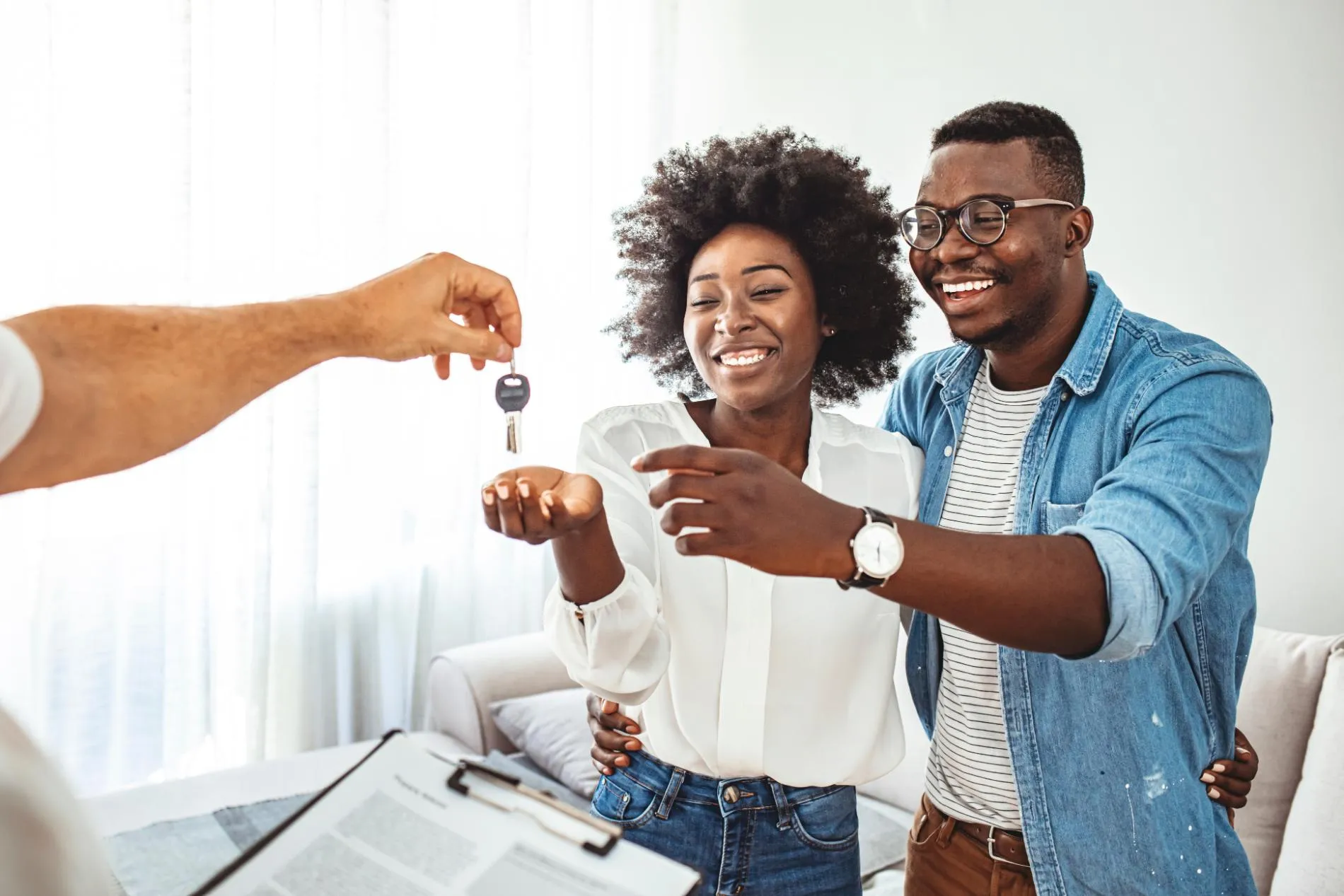A happy couple receiving keys to their new home