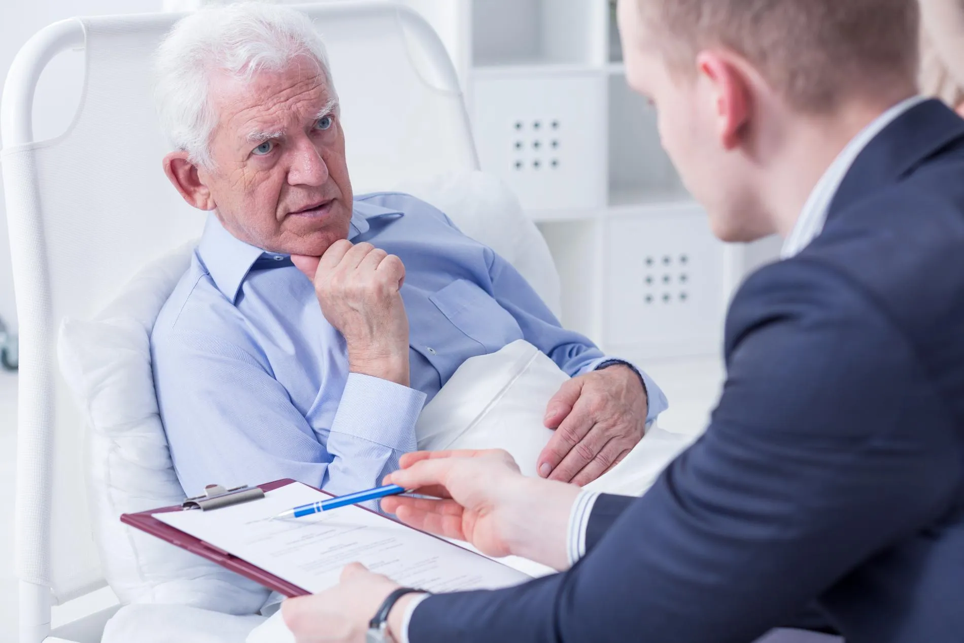 A man on a hospital bed planning his will and estate
